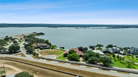 a view of a lake with a table and chairs