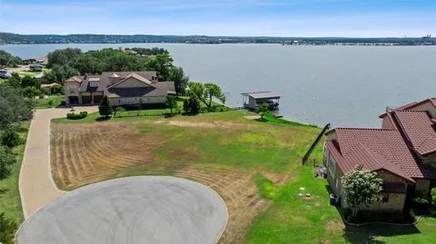 an aerial view of a house with outdoor space and lake view