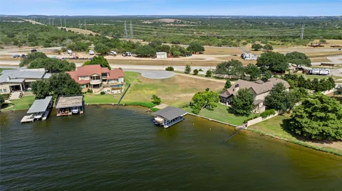 an aerial view of residential houses with outdoor space and ocean view