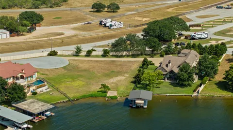 an aerial view of a house with a garden and lake view