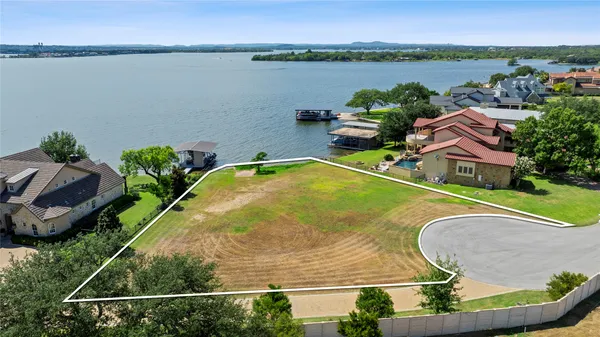 an aerial view of a house with outdoor space and lake view
