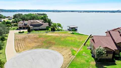 an aerial view of a house with swimming pool and ocean view