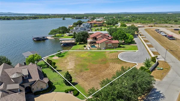 an aerial view of a house with a swimming pool and a yard