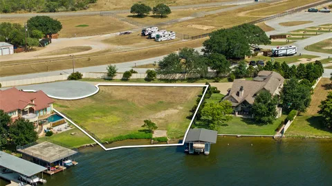 an aerial view of a pool with a yard