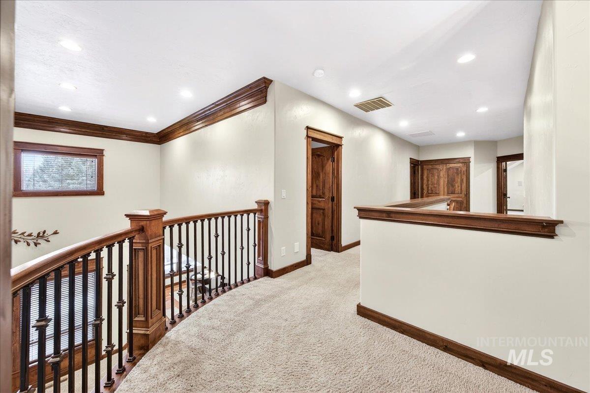 5627 North Morpheus Place Meridian, ID 83646 - Photo 36 of 50 Hall featuring light colored carpet, an upstairs landing, and recessed lighting