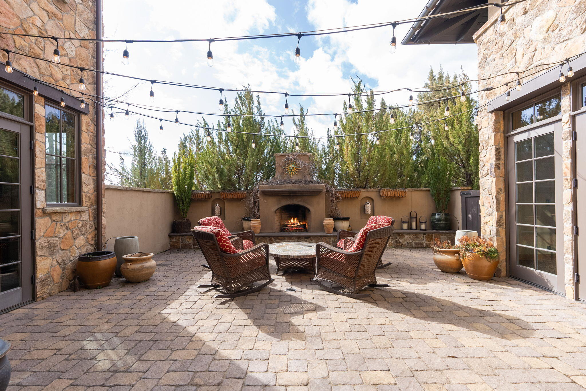 22887 Ghost Tree Lane Bend, OR 97701 - Photo 28 of 97 Multiple French doors open to a paver patio courtyard, complete with fireplace.