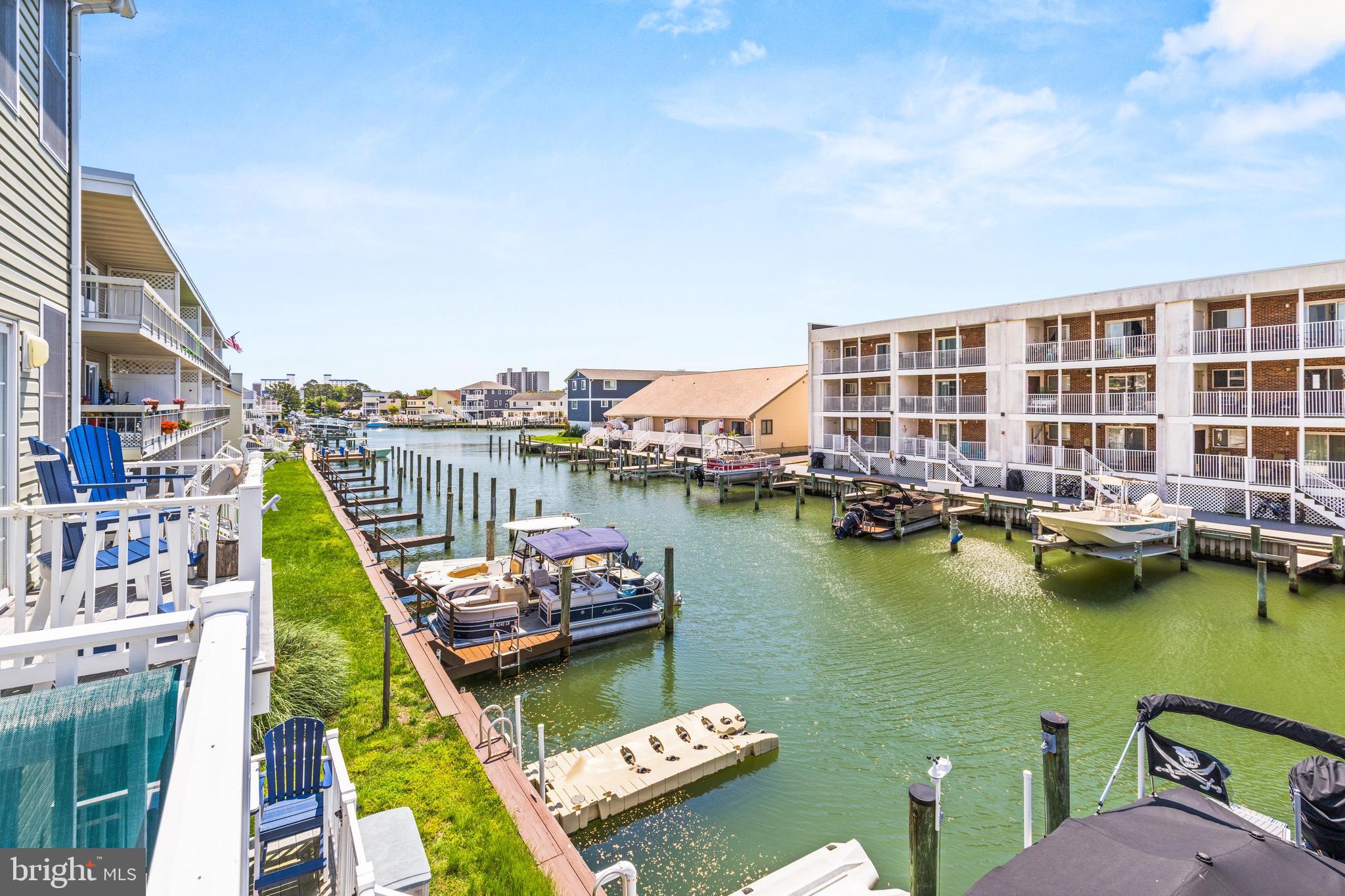 617 Salt Spray Road, Unit B Ocean City, MD 21842 - Photo 39 of 72 a view of a lake with a chairs and city view