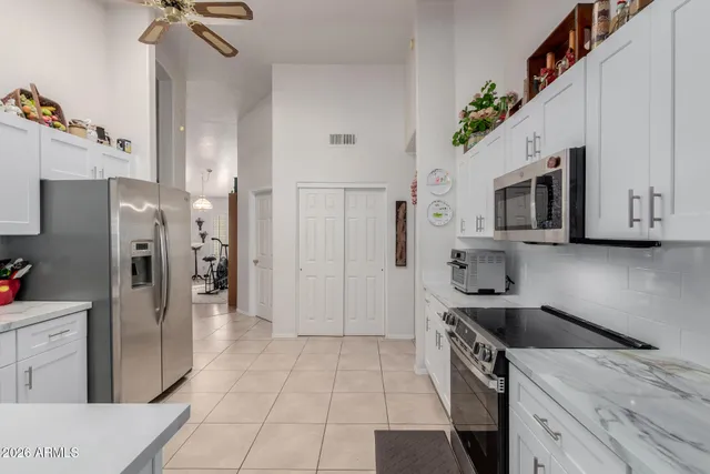 a kitchen with stainless steel appliances a refrigerator a stove a microwave and island