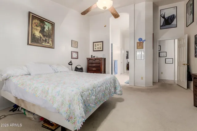 a spacious bedroom with a bed and a chandelier