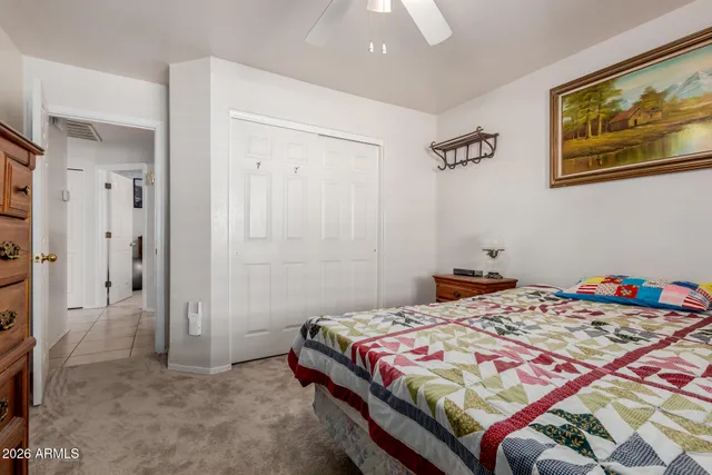 a bedroom with a bed and a painting on the wall