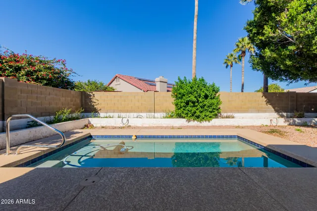 a view of swimming pool with outdoor seating and plants
