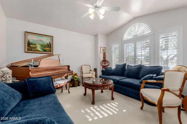 a living room with furniture a chandelier and a window
