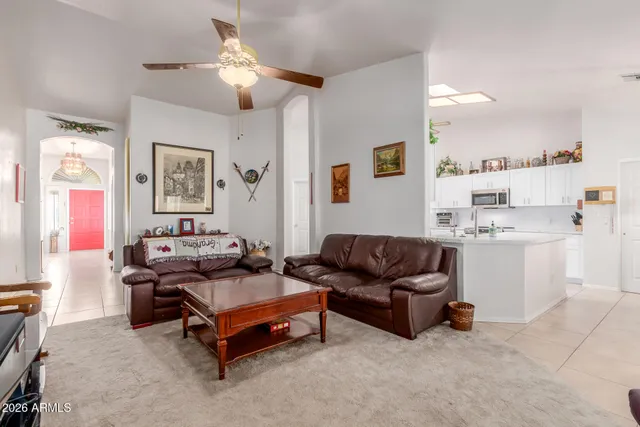 a living room with furniture and a view of kitchen