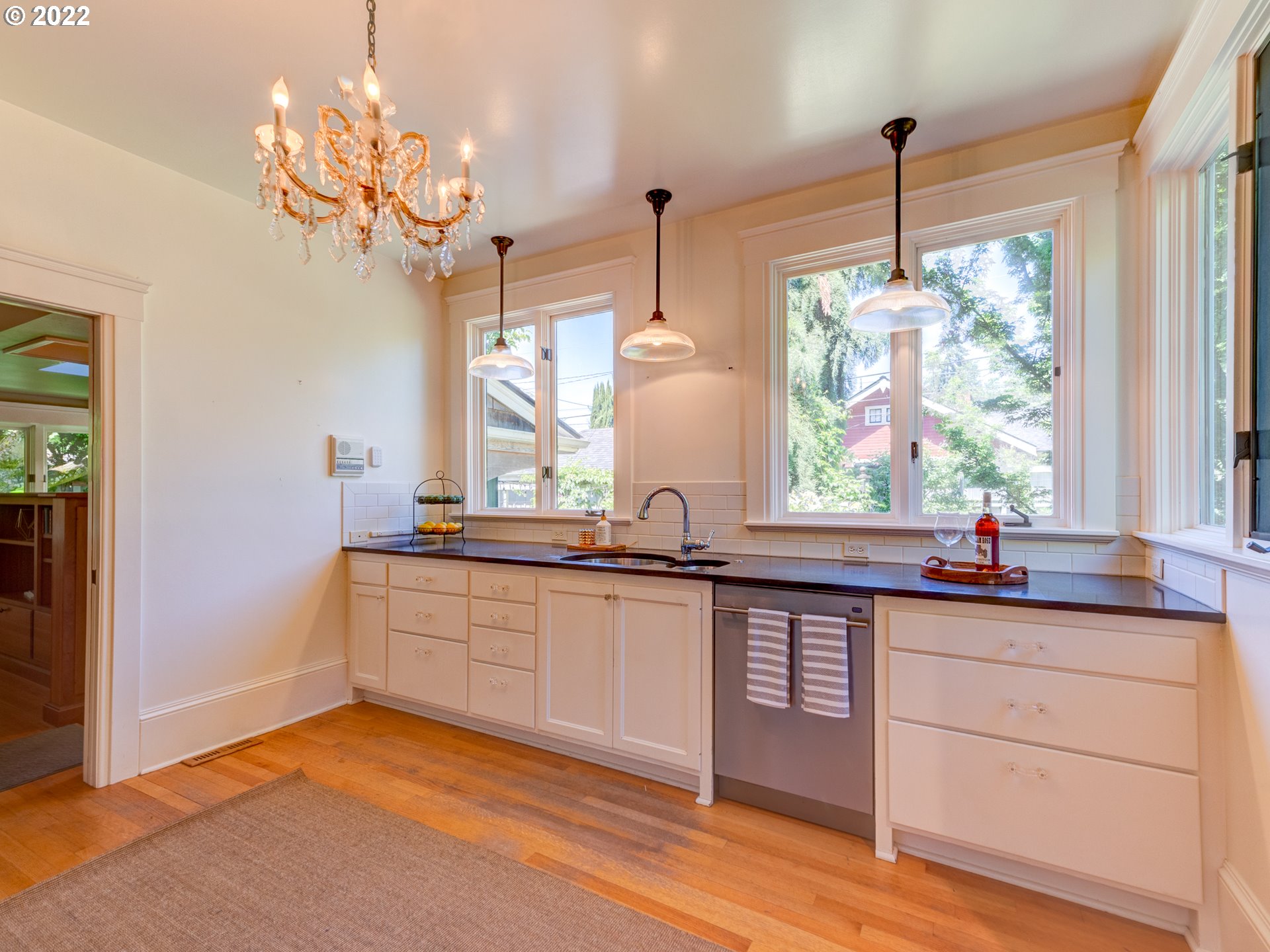 448 D Street Springfield, OR 97477 - Photo 10 of 32 a kitchen with a sink window and cabinets