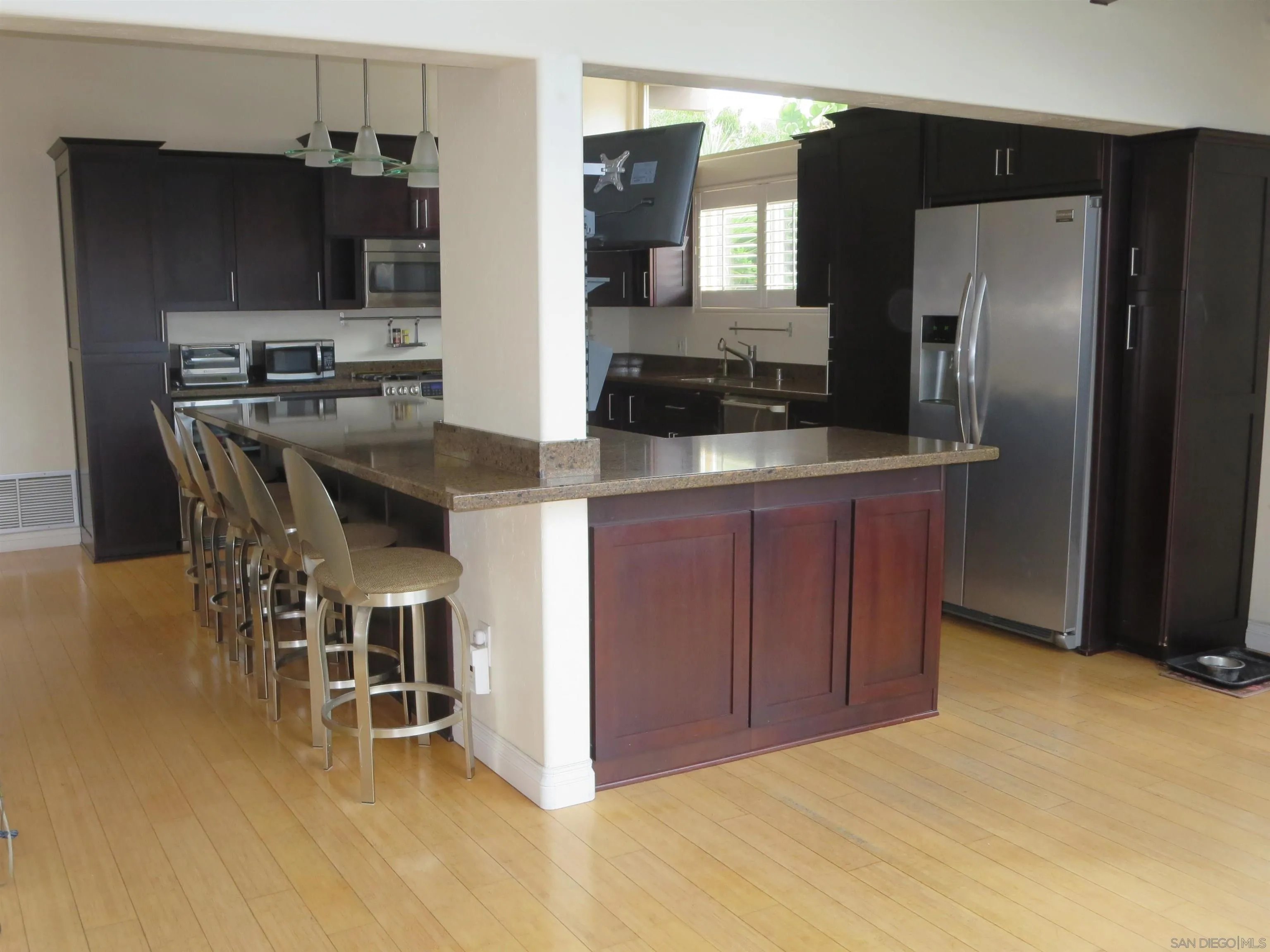14223 Frame Road Poway, CA 92064 - Photo 11 of 44 a kitchen with stainless steel appliances kitchen island granite countertop a refrigerator and a stove top oven