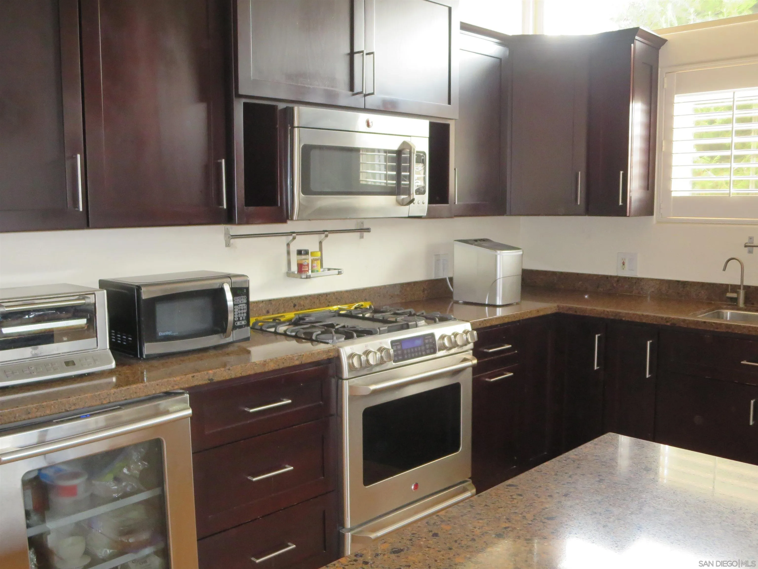 14223 Frame Road Poway, CA 92064 - Photo 13 of 44 a kitchen with stainless steel appliances a stove microwave and sink