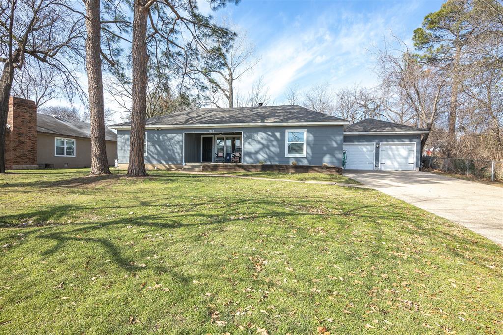 a view of a house with a yard outdoor seating and garage