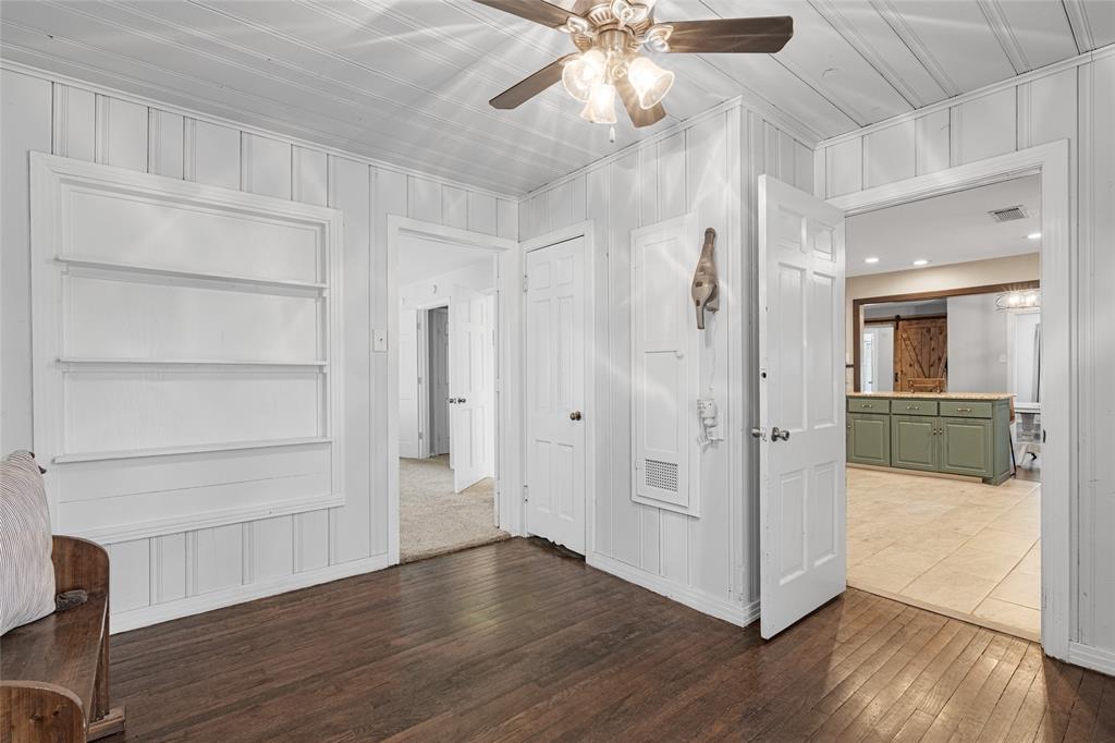 1308 Myrtle Street Denton, TX 76201 - Photo 14 of 35 a view of a hallway with wooden floor and a ceiling fan