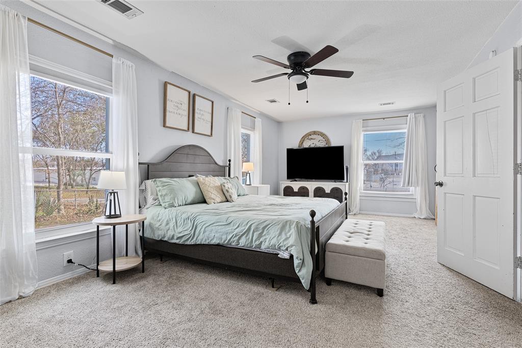 1308 Myrtle Street Denton, TX 76201 - Photo 24 of 35 a bed room with a bed window and a flat screen tv