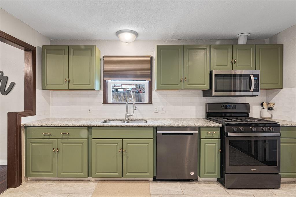 1308 Myrtle Street Denton, TX 76201 - Photo 28 of 35 a kitchen with a sink and a stove top oven