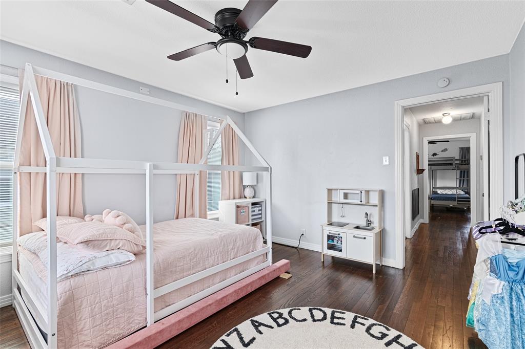 1308 Myrtle Street Denton, TX 76201 - Photo 29 of 35 a bedroom with a large bed and a chandelier