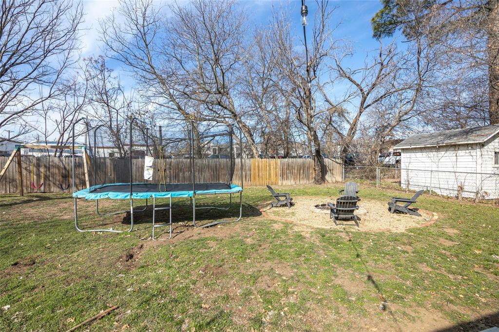 1308 Myrtle Street Denton, TX 76201 - Photo 34 of 35 a view of backyard with a table and chairs and wooden fence