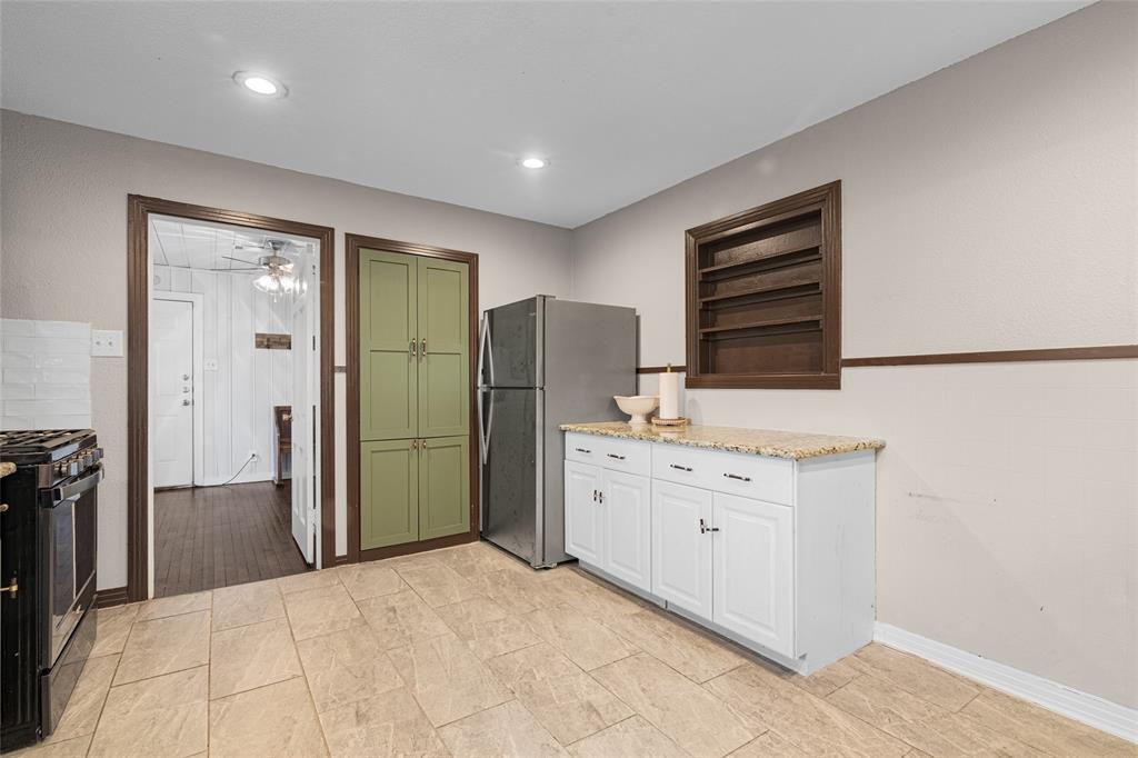 1308 Myrtle Street Denton, TX 76201 - Photo 7 of 35 a bathroom with a double vanity sink a mirror and a shower