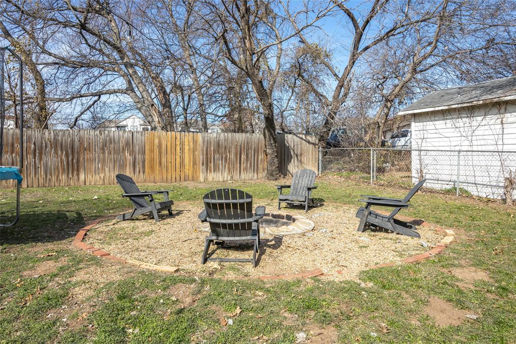 1308 Myrtle Street Denton, TX 76201 - Photo 9 of 35 a view of backyard with table and chairs and wooden fence