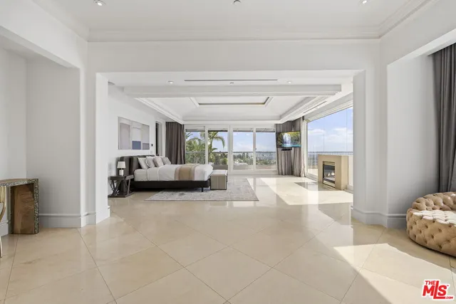 a spacious bedroom with a large bed and a large window