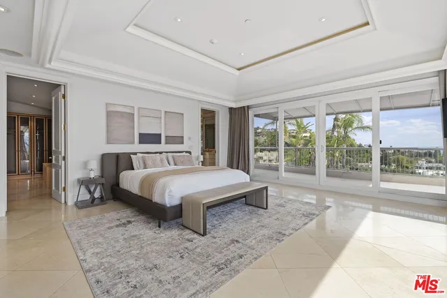 a spacious bedroom with a large bed and a fireplace