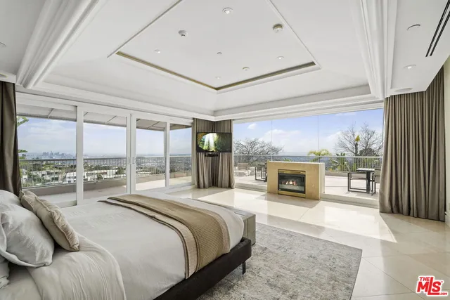 a bedroom with a large bed and a large window