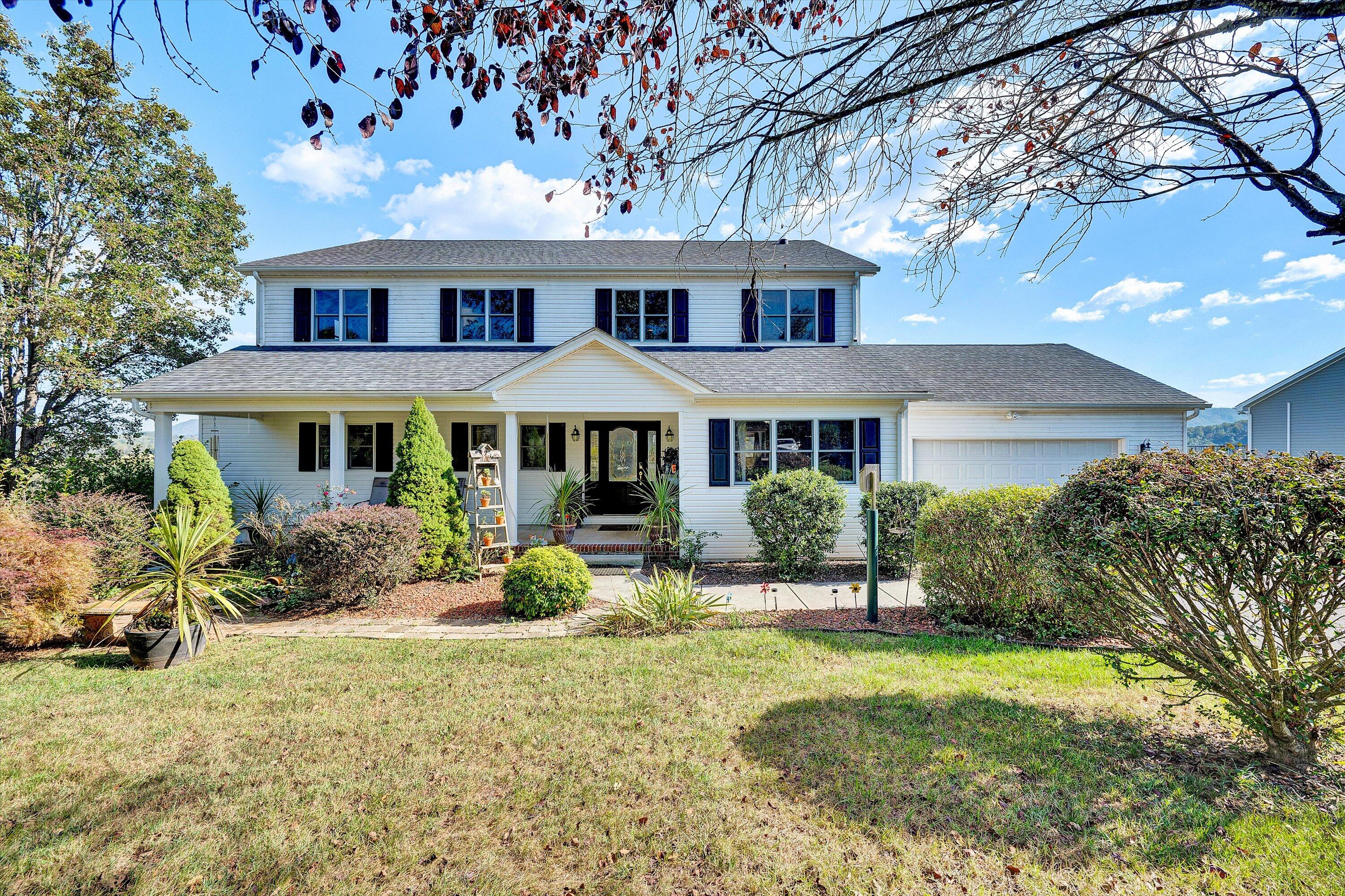 a front view of a house with yard and sitting area