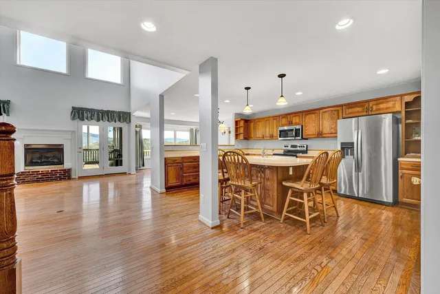 a view of empty room with wooden floor and fireplace