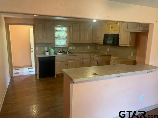 a kitchen with a sink and a stove top oven