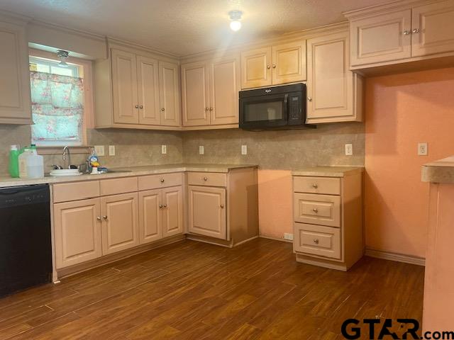 11787 Wood Springs Road Tyler, TX 75706 - Photo 4 of 13 a kitchen with stainless steel appliances a stove microwave and cabinets