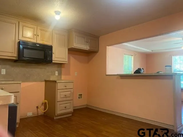 a view of a storage and utility room with wooden floor
