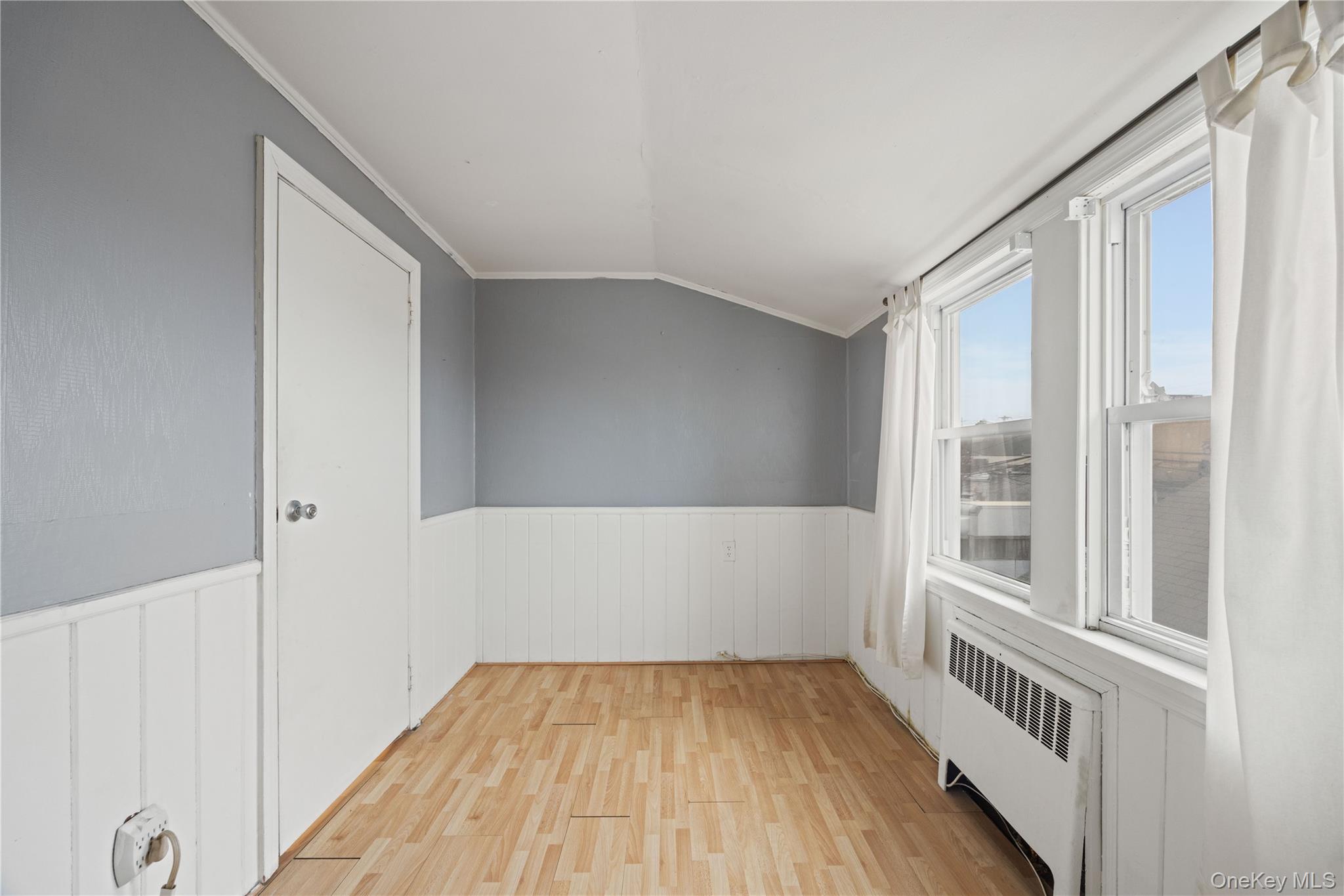 96 Warwick Road Island Park, NY 11558 - Photo 12 of 13 a view of an empty room with wooden floor and a window