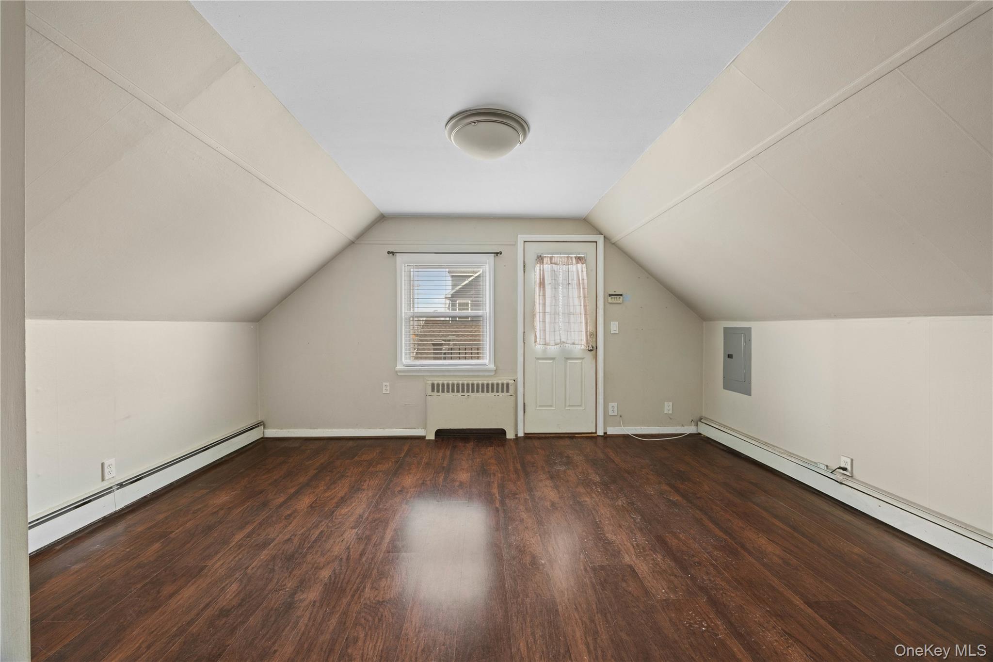 96 Warwick Road Island Park, NY 11558 - Photo 5 of 13 an empty room with wooden floor and windows