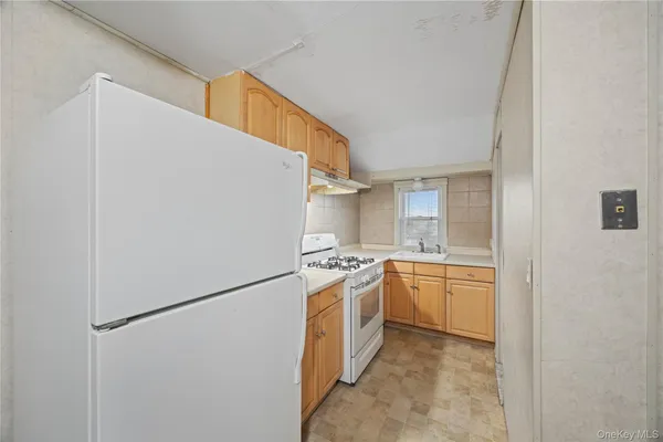 a kitchen with stainless steel appliances granite countertop a refrigerator and a stove