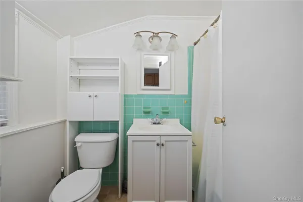 a bathroom with a sink mirror vanity and toilet