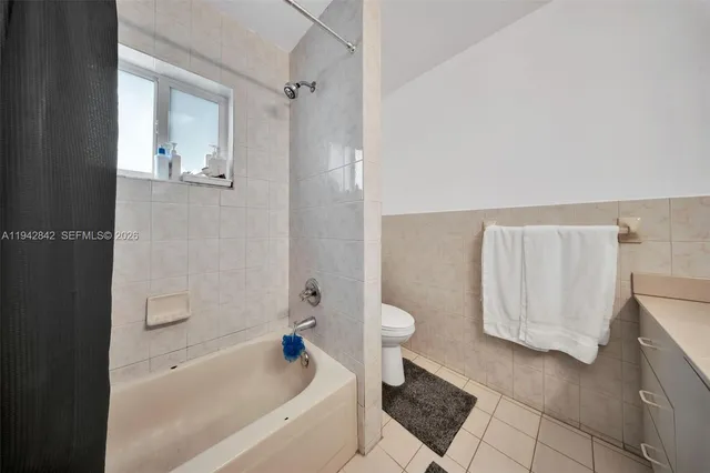 a bathroom with a bathtub and a toilet