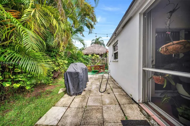 a view of a porch with chairs and potted plants