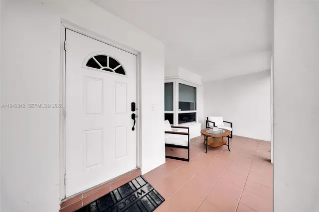 a living room with furniture and a book shelf