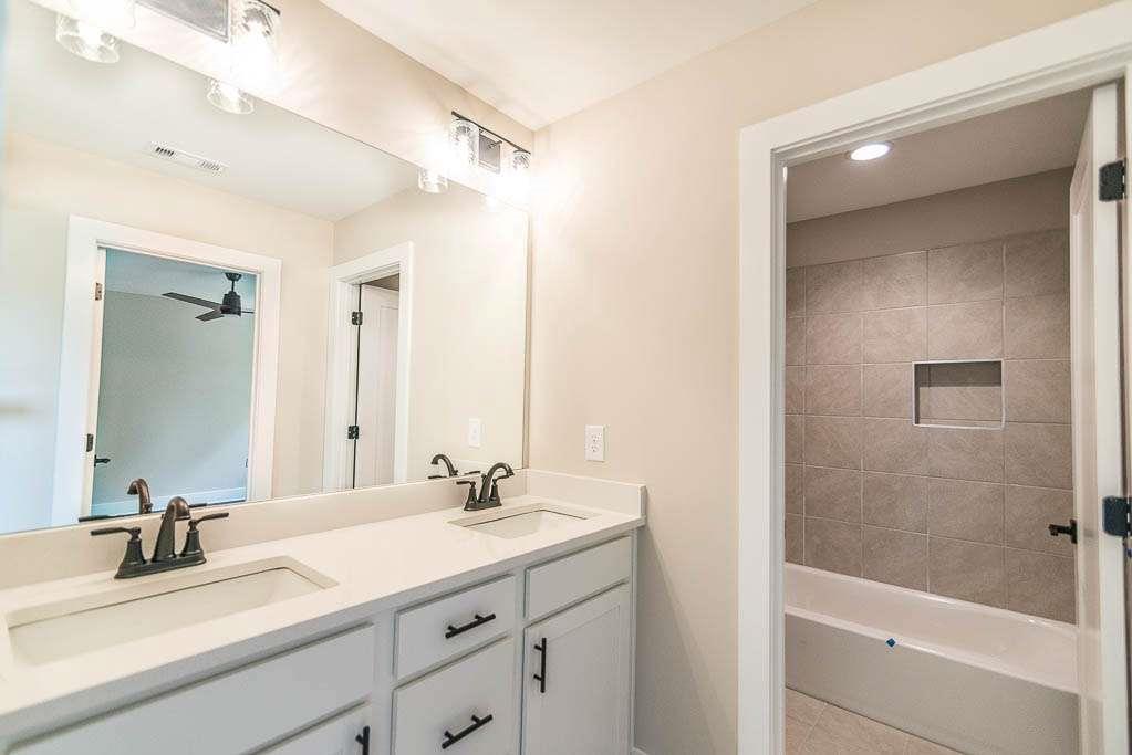 2545 Waldrop Ridge Court Decatur, GA 30034 - Photo 14 of 31 a bathroom with a shower sink vanity and mirror
