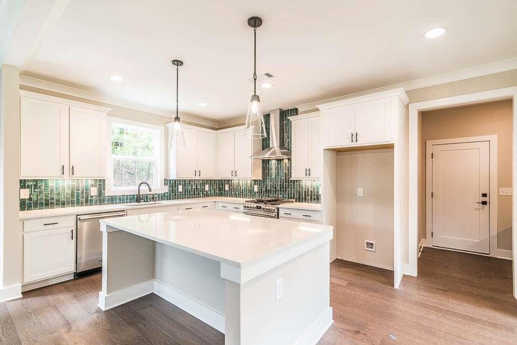 2545 Waldrop Ridge Court Decatur, GA 30034 - Photo 2 of 31 a kitchen with a refrigerator a stove and a wooden floor