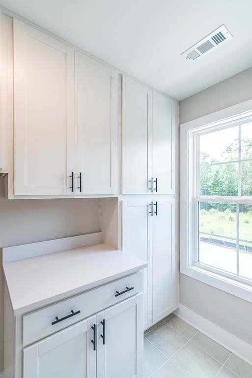 2545 Waldrop Ridge Court Decatur, GA 30034 - Photo 25 of 31 a kitchen with a white cabinets and a stove