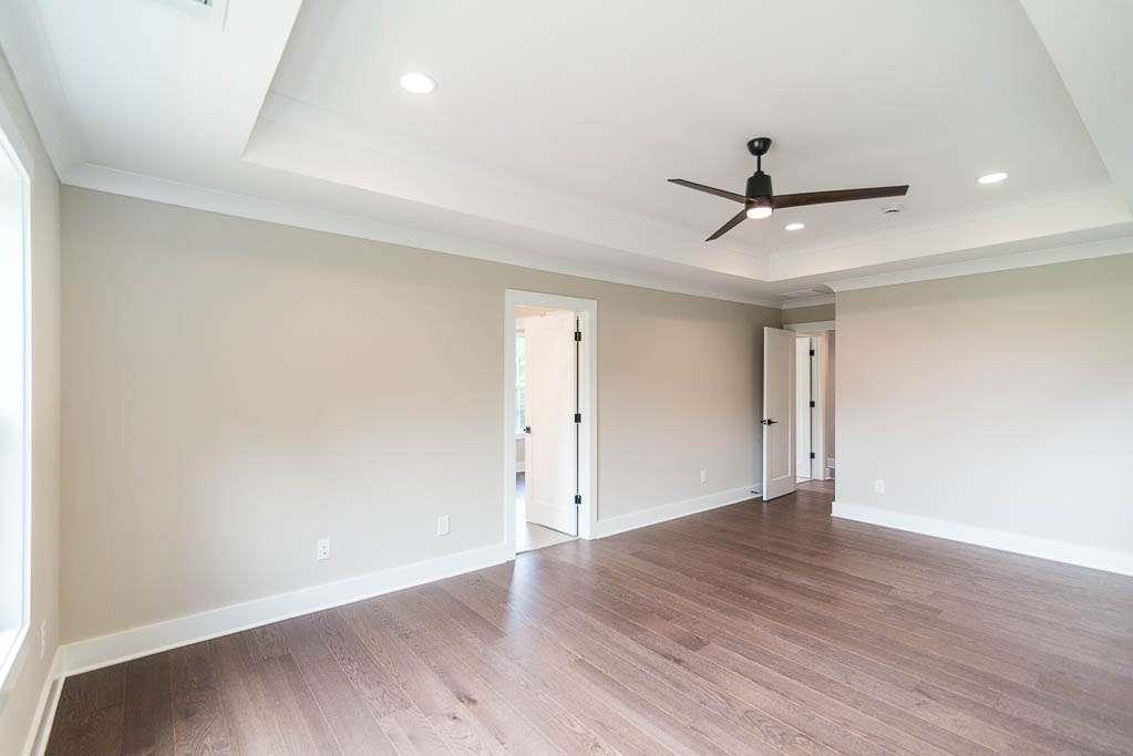 2545 Waldrop Ridge Court Decatur, GA 30034 - Photo 27 of 31 an empty room with wooden floor and ceiling fan