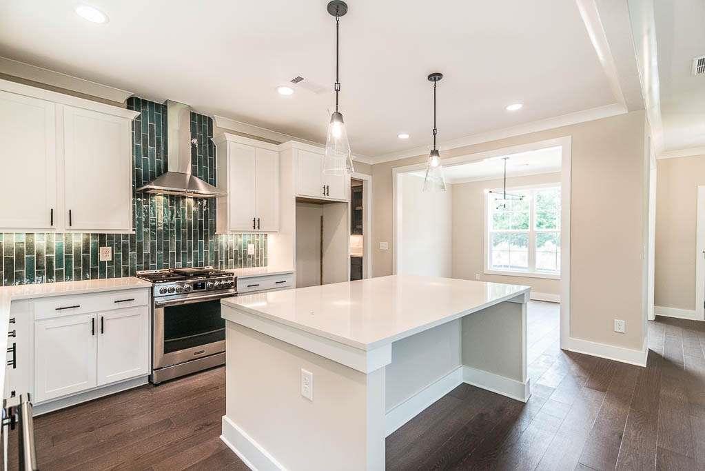 2545 Waldrop Ridge Court Decatur, GA 30034 - Photo 6 of 31 a large kitchen with white cabinets and stainless steel appliances
