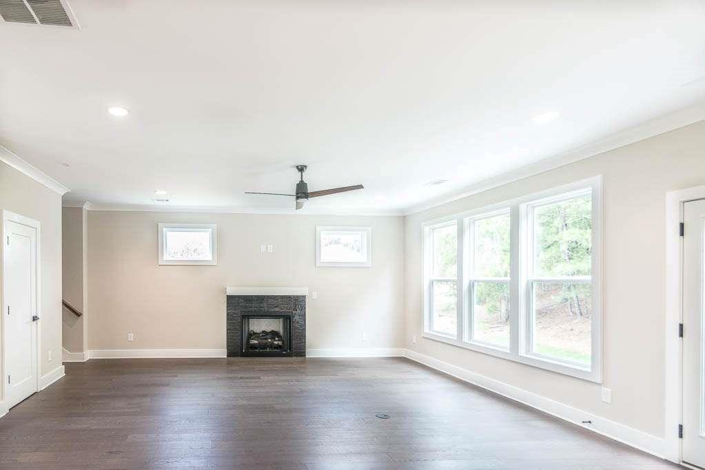 2545 Waldrop Ridge Court Decatur, GA 30034 - Photo 9 of 31 an empty room with wooden floor fireplace and windows