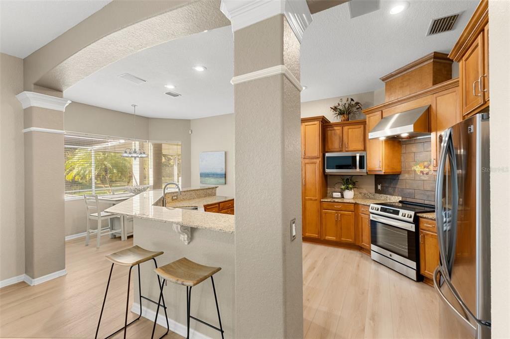 12305 Twin Branch Acres Road Tampa, FL 33626 - Photo 13 of 66 a kitchen with stainless steel appliances a stove top oven a sink and a refrigerator